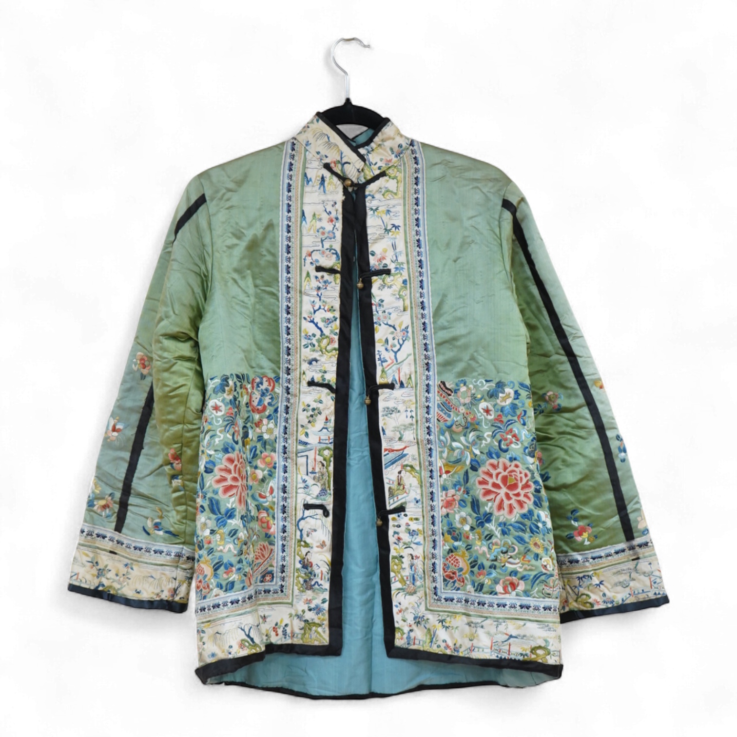 An early 20th century Chinese green silk polychrome embroidered jacket. Worked with Chinese knot embroidery and stem stitch into flowers, butterflies and bats, edged with woven silk ribbon and a figurative embroidered bo